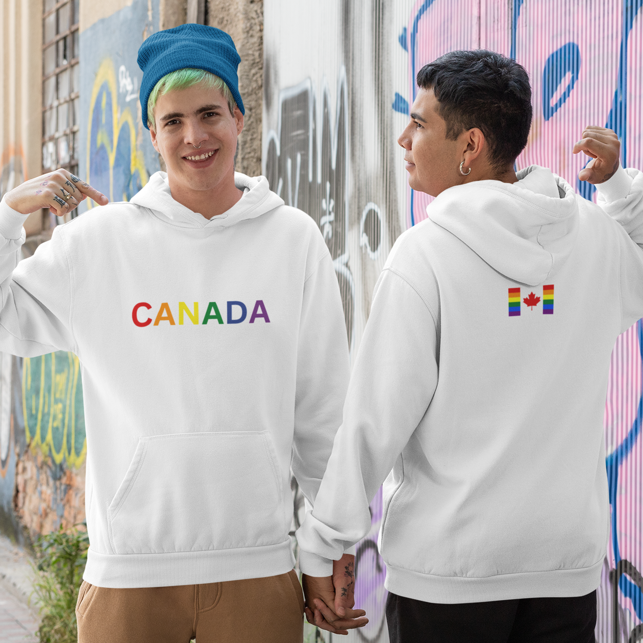 A couple displaying their pride hoodies